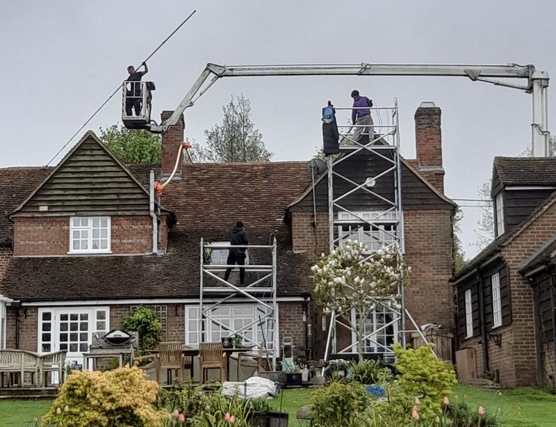 The Roof Moss Cleaners using cherry picker and scaffolding to clean roof safely and professionally in Stevenage, Hertfordshire